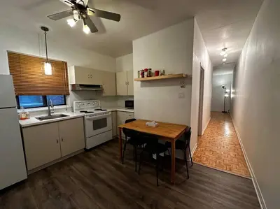 a kitchen with a table and a kitchen with a ceiling fan at Fully furnished 2 bedroom unit, downtown, near subway, 32 days minimum in Montréal