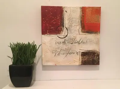 a painting and a vase with a plant on a wall at Fully furnished 2 bedroom unit, downtown, near subway, 32 days minimum in Montréal
