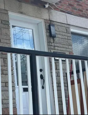 a front door of a house with a rail at Chambres à louer in Montréal