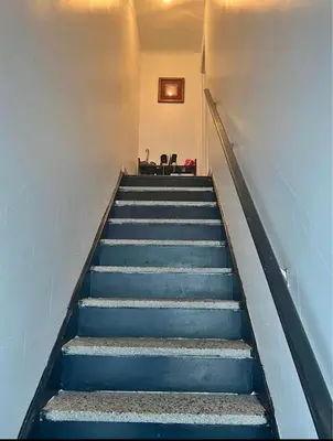a staircase with blue steps with a chair on it at Chambres à louer in Montréal