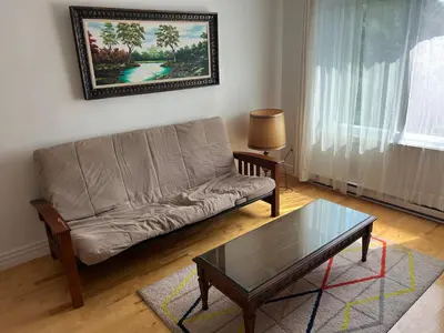 a living room with a couch and a coffee table at Chambres à louer in Montréal