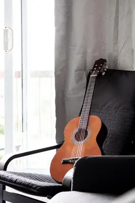 a guitar sitting on a couch next to a window at Cozy 2-Bedroom à Plateau-Mont-Royal in Montréal