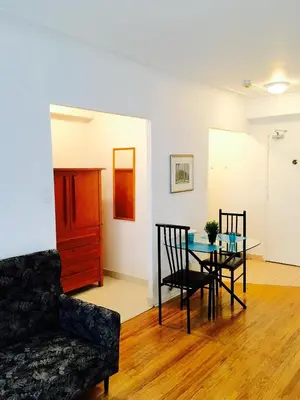 a living room with a couch and a table at Stylish Montreal Apartment Comfortable Stay in the Golden Square Mile in Montréal