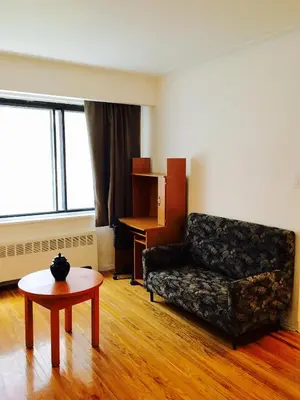 a living room with a couch and a table at Stylish Montreal Apartment Comfortable Stay in the Golden Square Mile in Montréal
