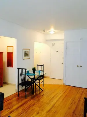 a dining room with a table and chairs in a room at Stylish Montreal Apartment Comfortable Stay in the Golden Square Mile in Montréal