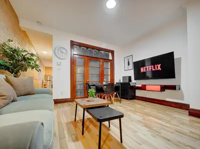 a living room with a couch and a tv at Great 3B unit on Saint-Urbain in Montréal