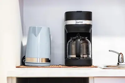 a coffee maker on a shelf next to a coffee pot at Great 3B unit on Saint-Urbain in Montréal