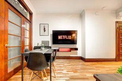 a dining room with a television and a table and chairs at Great 3B unit on Saint-Urbain in Montréal