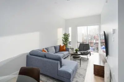 a living room with a blue couch and a table at The S&D Apartments in Montréal
