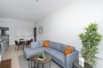 a living room with a blue couch and a table at The S&D Apartments in Montréal