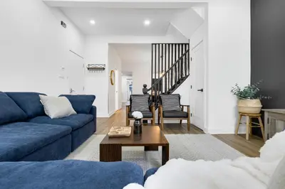 a living room with a blue couch and a table at Boutique 4BR Luxury Residence 2 Floors Mile-End St-Laurent in Montréal