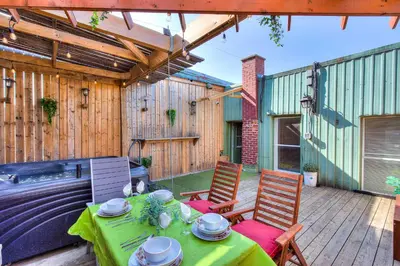 a patio with a table and chairs on a deck at Premier destination for Big Groups MTL Vacation and Nightlife in Montréal