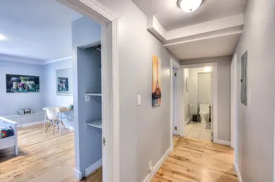 a hallway with blue walls and wooden flooring in a apartment at Premier destination for Big Groups MTL Vacation and Nightlife in Montréal