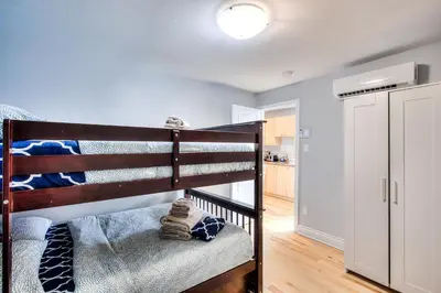 a bedroom with a bunk bed and a kitchen at Premier destination for Big Groups MTL Vacation and Nightlife in Montréal
