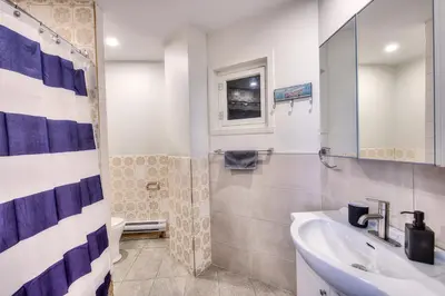 a bathroom with a sink and a shower and a toilet at Premier destination for Big Groups MTL Vacation and Nightlife in Montréal