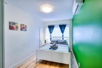a bedroom with a bed with blue and green walls at Premier destination for Big Groups MTL Vacation and Nightlife in Montréal