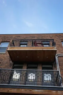 a building with balconies on the side of it at cute 2 bedroom unit, ground floor, downtown, 32 days minimum in Montréal