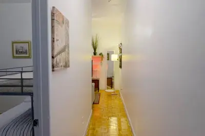 a hallway leading to a bedroom with white walls at cute 2 bedroom unit, ground floor, downtown, 32 days minimum in Montréal