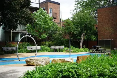 a park with two benches and two rocks at cute 2 bedroom unit, ground floor, downtown, 32 days minimum in Montréal