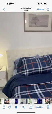 a bedroom with a bed with a plaid blanket at Marlene in Montréal