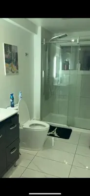 a bathroom with a shower and a toilet and a sink at Marlene in Montréal