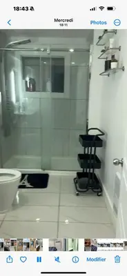 a bathroom with a toilet and a chair in it at Marlene in Montréal