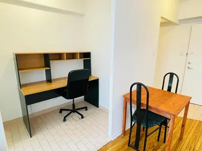 an office with a desk and two chairs and a table at Stylish Montreal Apartment Comfortable Stay in the Golden Square Mile in Montréal