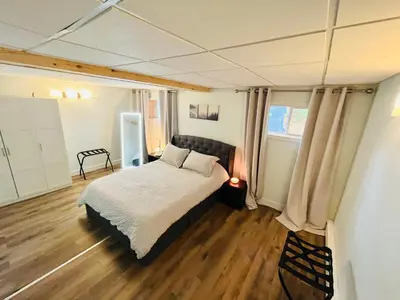 a bedroom with a bed and wooden floors at Main Street in North Hatley