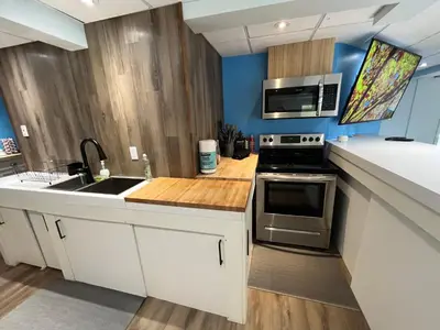 a kitchen with a sink and a microwave at Main Street in North Hatley