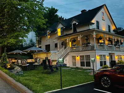 a large house with a porch and a patio at Main Street in North Hatley