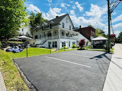 a parking lot in front of a large house at Main Street in North Hatley