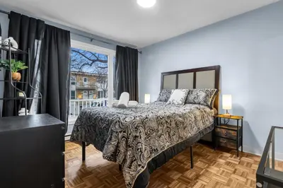 a bedroom with a bed and a window at COSY 3 BEDROOMS Montreal in Montréal