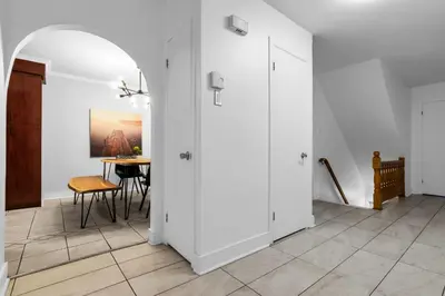 a hallway with white doors and a table at COSY 3 BEDROOMS Montreal in Montréal