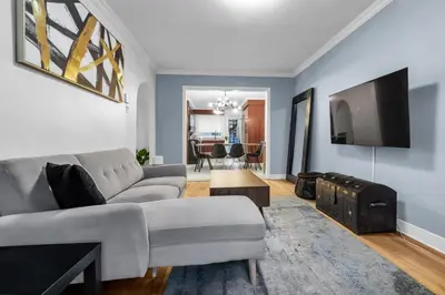 a living room with a couch and a tv at COSY 3 BEDROOMS Montreal in Montréal