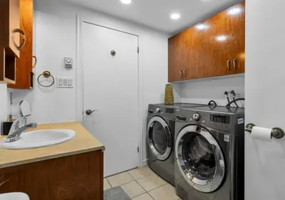 a laundry room with a washing machine and a sink at COSY 3 BEDROOMS Montreal in Montréal