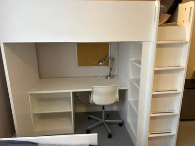 a desk with a chair and a desk with shelves at La maison internationale de Montréal in Montréal