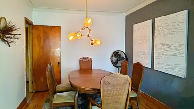 a dining room with a wooden table and chairs at Urbanity et cosy in Montréal