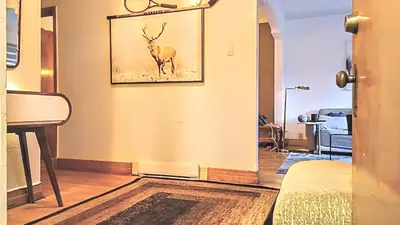 a room with a painting of a deer on the wall at Urbanity et cosy in Montréal