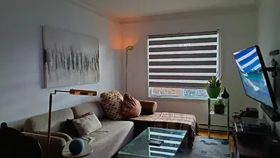 a living room with a couch and a window at Urbanity et cosy in Montréal