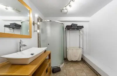 a bathroom with a sink and a shower at Le Loft in North Hatley