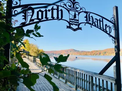 a metal gate with a view of a lake at Le Loft in North Hatley