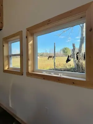 a window in a room with horses in a field at Le Garage 17 in Frelighsburg