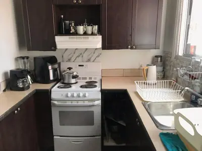 a kitchen with a white stove and a sink at Chambre spacieuse in Montréal