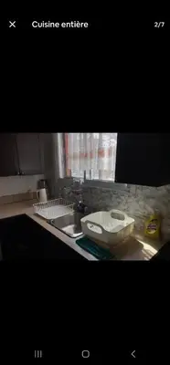 a kitchen counter top with a sink and a sink at Chambre spacieuse in Montréal