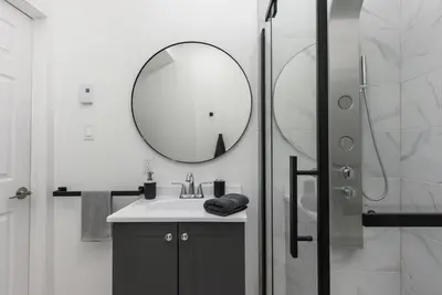a bathroom with a sink and a mirror at Three bedroom chic condo downtown Montreal in Montréal