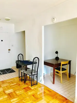 a dining room with a table and chairs at Stylish Montreal Apartment Comfortable Stay in the Golden Square Mile in Montréal