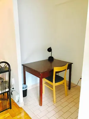 a wooden table with a lamp and a yellow chair at Stylish Montreal Apartment Comfortable Stay in the Golden Square Mile in Montréal