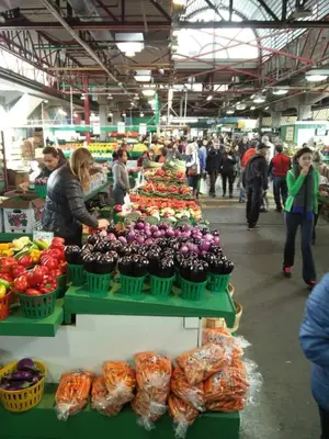 a group of people in a market with vegetables on display at Huge 3 Bedroom Condo with a Large Patio in Montréal