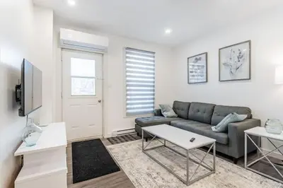 a living room with a couch and a table at Huge 3 Bedroom Condo with a Large Patio in Montréal