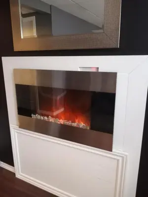 a white fireplace with a fire in it at Villa le Voyageur in Sherbrooke
